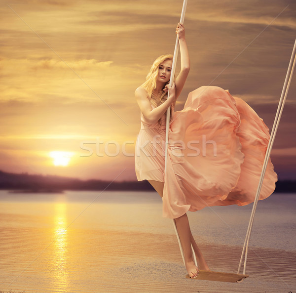 Slim lady standing on the seesaw Stock photo © konradbak