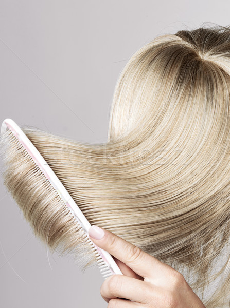 Blond hairpiece brushed by a woman Stock photo © konradbak