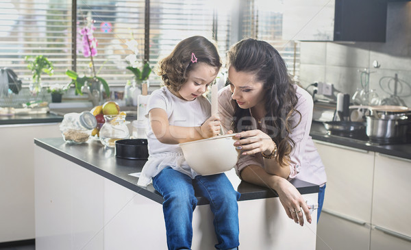 Stock photo: Mother and daughter whisking cake in the bowl