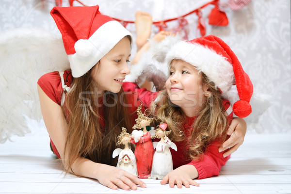 Two little sisters with toy angels Stock photo © konradbak