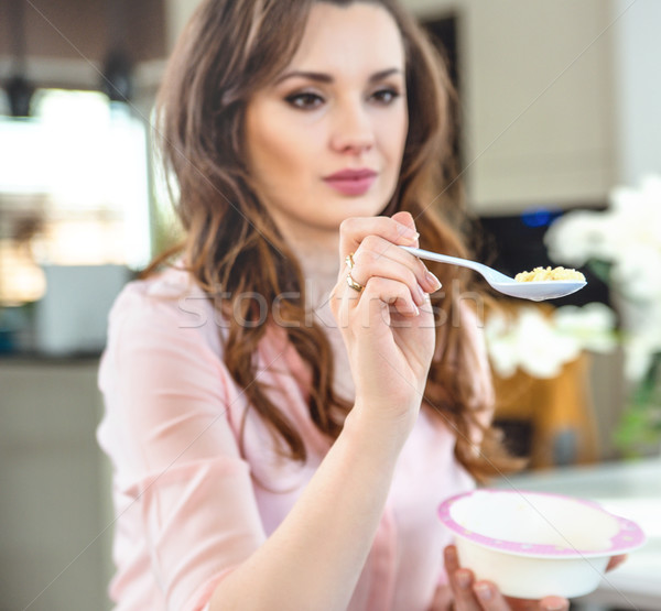 Portrait of a young lady feeding a baby Stock photo © konradbak