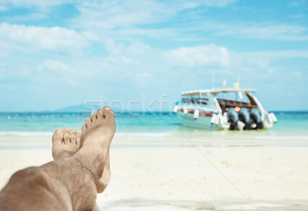 Conceptual picture of relaxing person on an asian beach Stock photo © konradbak