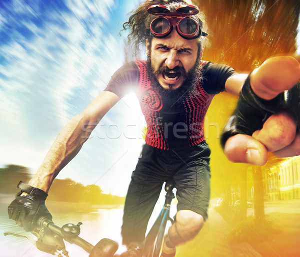 Funny image of a shouting cyclist Stock photo © konradbak