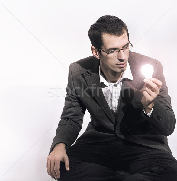 Geschäftsmann halten Glühlampe Business Mann abstrakten Stock foto © konradbak