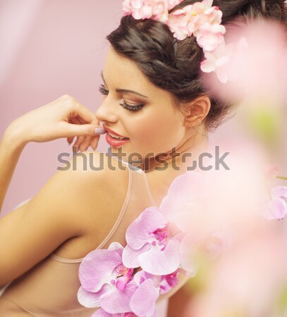 Pleased brunette woman among the flowers Stock photo © konradbak
