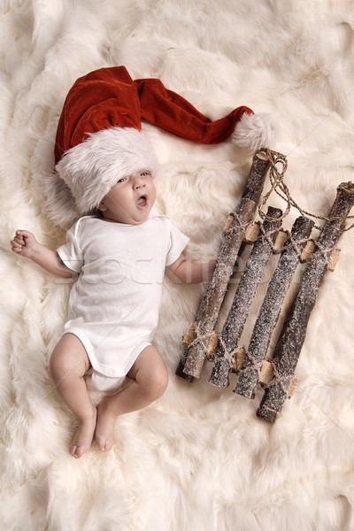 Yawning newborn child wearing a santa's hat Stock photo © konradbak