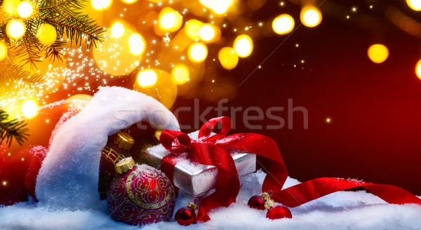 Christmas gift box and holidays lights on red background Stock photo © Konstanttin