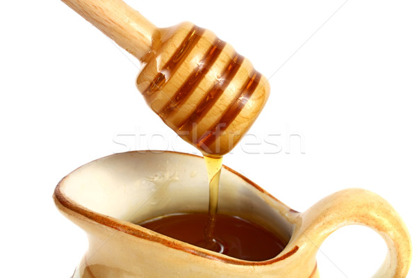 Stock photo: honey flowing down from a wooden stick