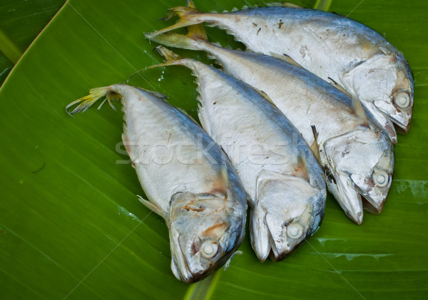 Stock photo: four boiled mackerel fish on green banana leaf