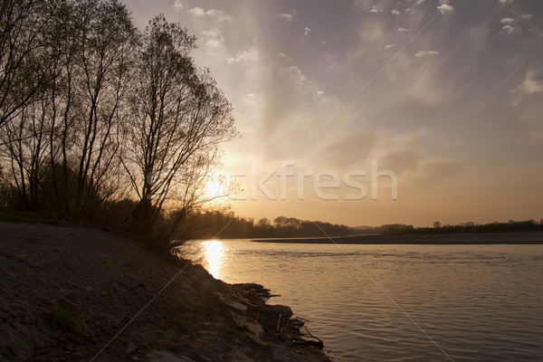 Puesta de sol lado río cielo agua sol Foto stock © Koufax73