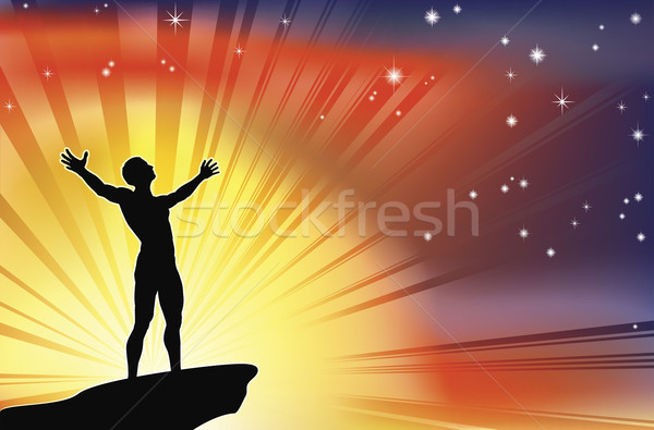 Stock photo: Man on cliff top with arms raised