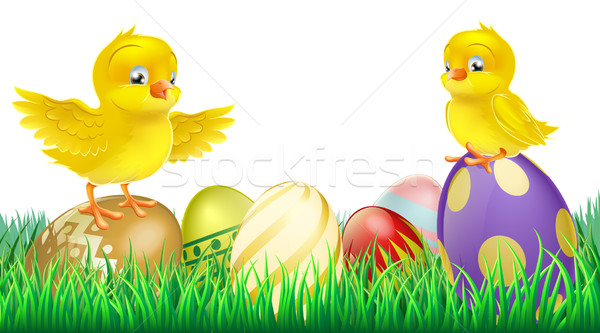 Cute yellow chicks on Easter eggs Stock photo © Krisdog