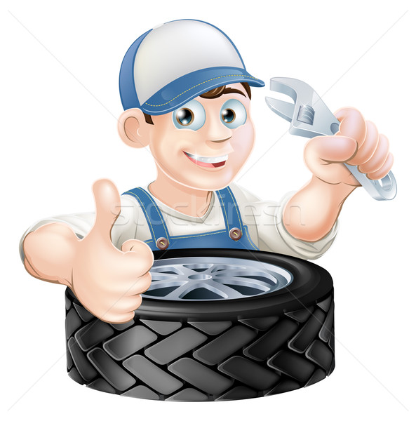Mechanic with spanner and tire Stock photo © Krisdog