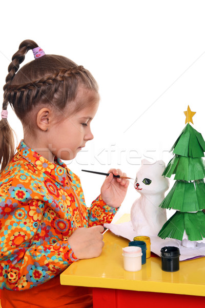 A girl paints the figure of a white cat  Stock photo © krugloff
