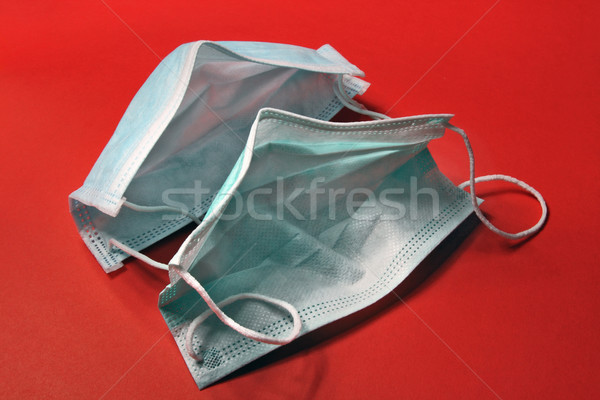 Disposable medical masks on a red background   Stock photo © krugloff