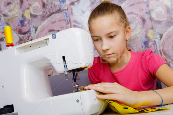 A teenage girl learns to sew Stock photo © krugloff