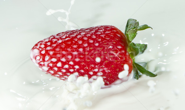 strawberry splashing into milk Stock photo © kubais