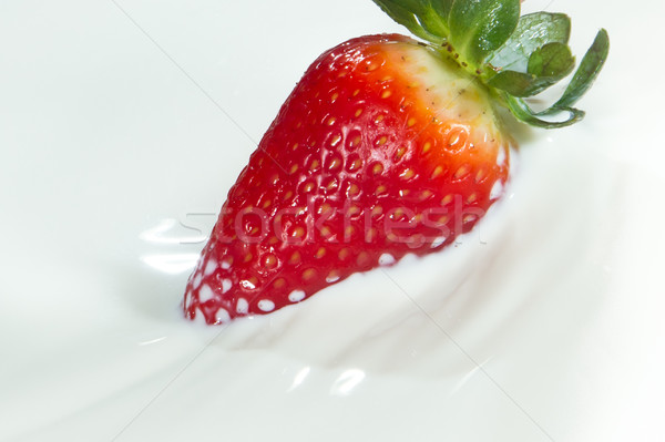 strawberry splashing into milk Stock photo © kubais
