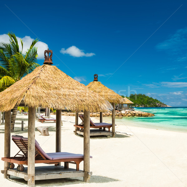 beach beds with roof and turquoise sea Stock photo © kubais