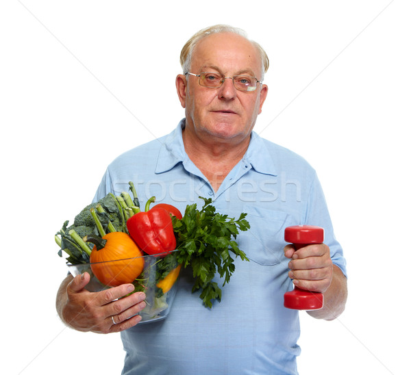 Senior man with vegetables and dumbbell. Stock photo © Kurhan