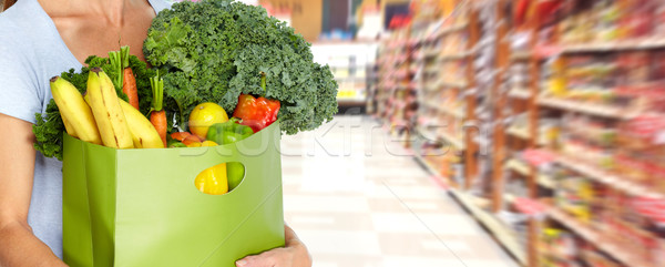 Stock photo: Woman hands with grocery bag of vegetables.