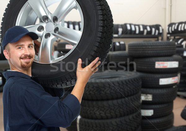 Car mechanic with a tire. Stock photo © Kurhan