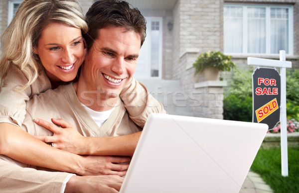 Couple with laptop near new house. Stock photo © Kurhan