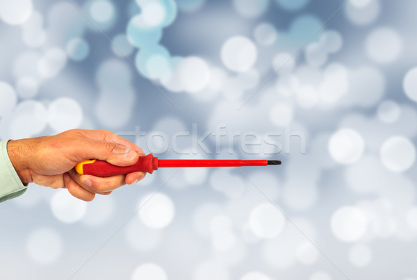 Hand of handyman with a screwdriver. Stock photo © Kurhan