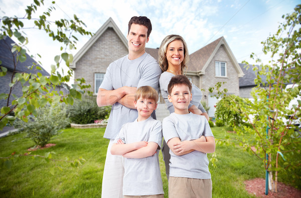 Happy family near new house. Stock photo © Kurhan