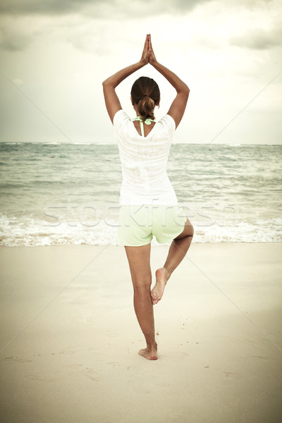 Woman doing yoga on Punta Cana beach. Stock photo © Kurhan