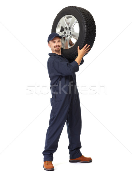 Car mechanic with a tire. Stock photo © Kurhan