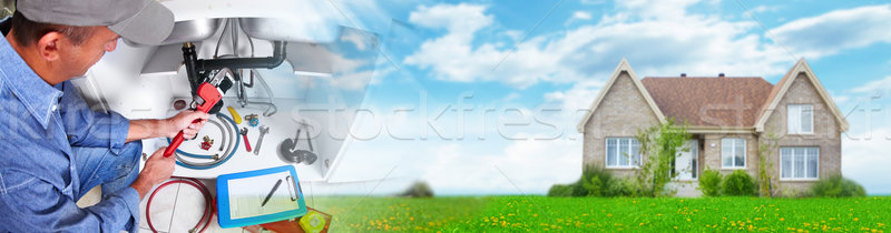 Hand of Plumber with a wrench. Stock photo © Kurhan