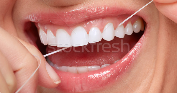 woman smile with tooth floss Stock photo © Kurhan