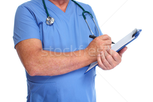 Hands of doctor with clipboard. Stock photo © Kurhan