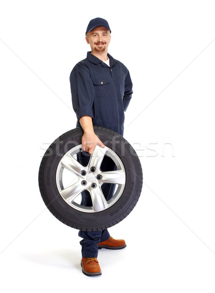 Car mechanic with a tire. Stock photo © Kurhan