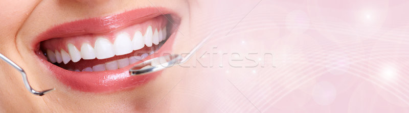 Woman teeth with dental instruments Stock photo © Kurhan
