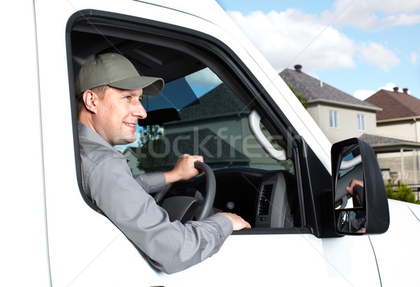 Jóképű teherautó sofőr mosolyog autó házhozszállítás Stock fotó © Kurhan