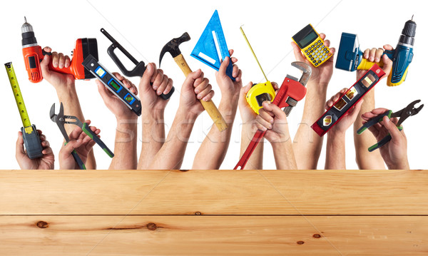 Stock photo: Hands with DIY tools.