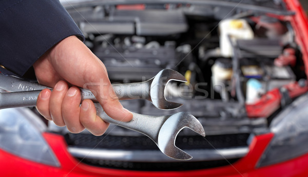   Hands of car mechanic in auto repair service.  Stock photo © Kurhan