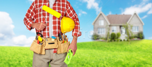 Builder handyman with paint roller. Stock photo © Kurhan