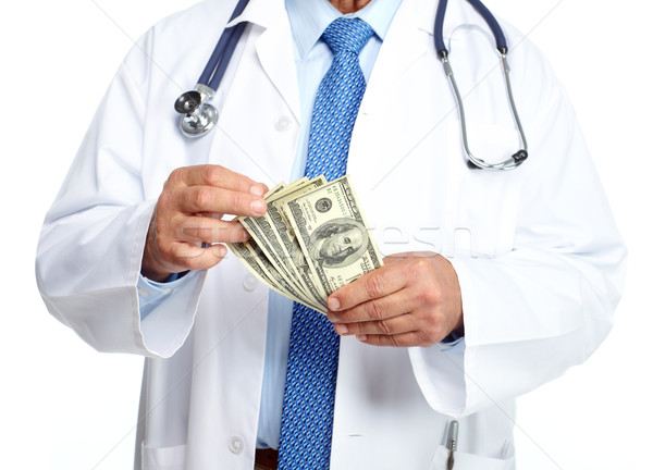 Hands of medical doctor with money. Stock photo © Kurhan