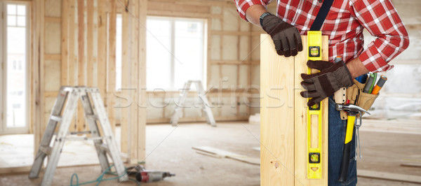 Builder with level and wooden planks. Stock photo © Kurhan