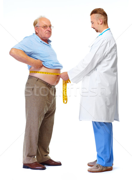 Doctor measuring obese man body fat. Stock photo © Kurhan