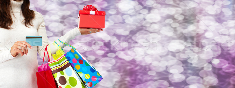 Woman hand with shopping bags and credit card. Stock photo © Kurhan