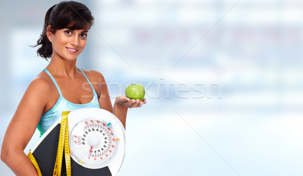 Young asian woman with apple and scales. Stock photo © Kurhan