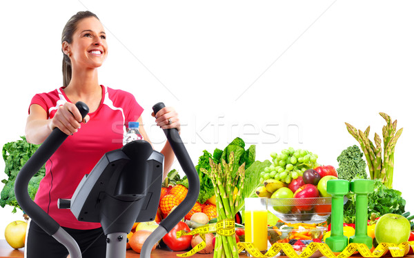 Young woman exercising on elliptical trainer. Stock photo © Kurhan