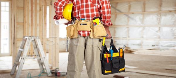 Hand of handyman with a tool bag. Stock photo © Kurhan