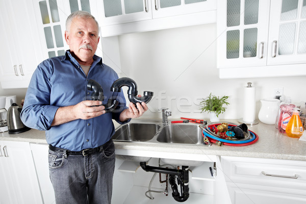 Plumber in kitchen with a wrench. Stock photo © Kurhan