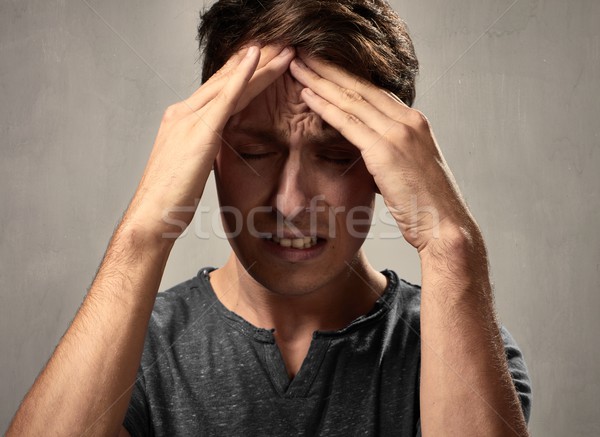Dor de cabeça deprimido homem cinza parede cara Foto stock © Kurhan