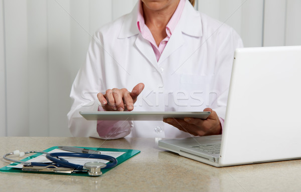 Stock photo: Doctor woman hands with tablet computer.